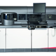 A grey and black machine, about five feet tall, seven feet long, three to four feet wide